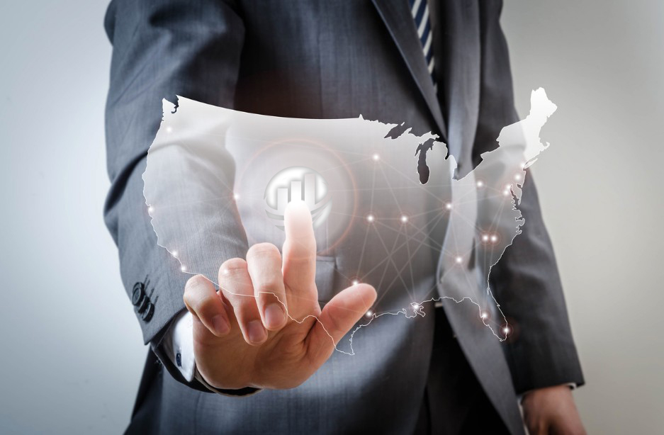 man in suit pointing at a map