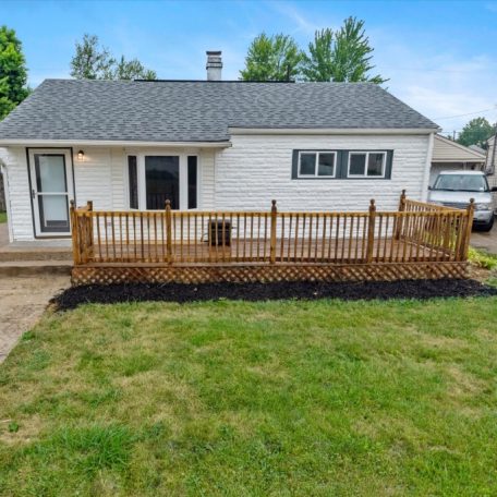 A house with a deck and a yard